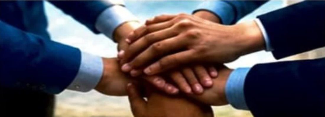 Many hands joined together in unity